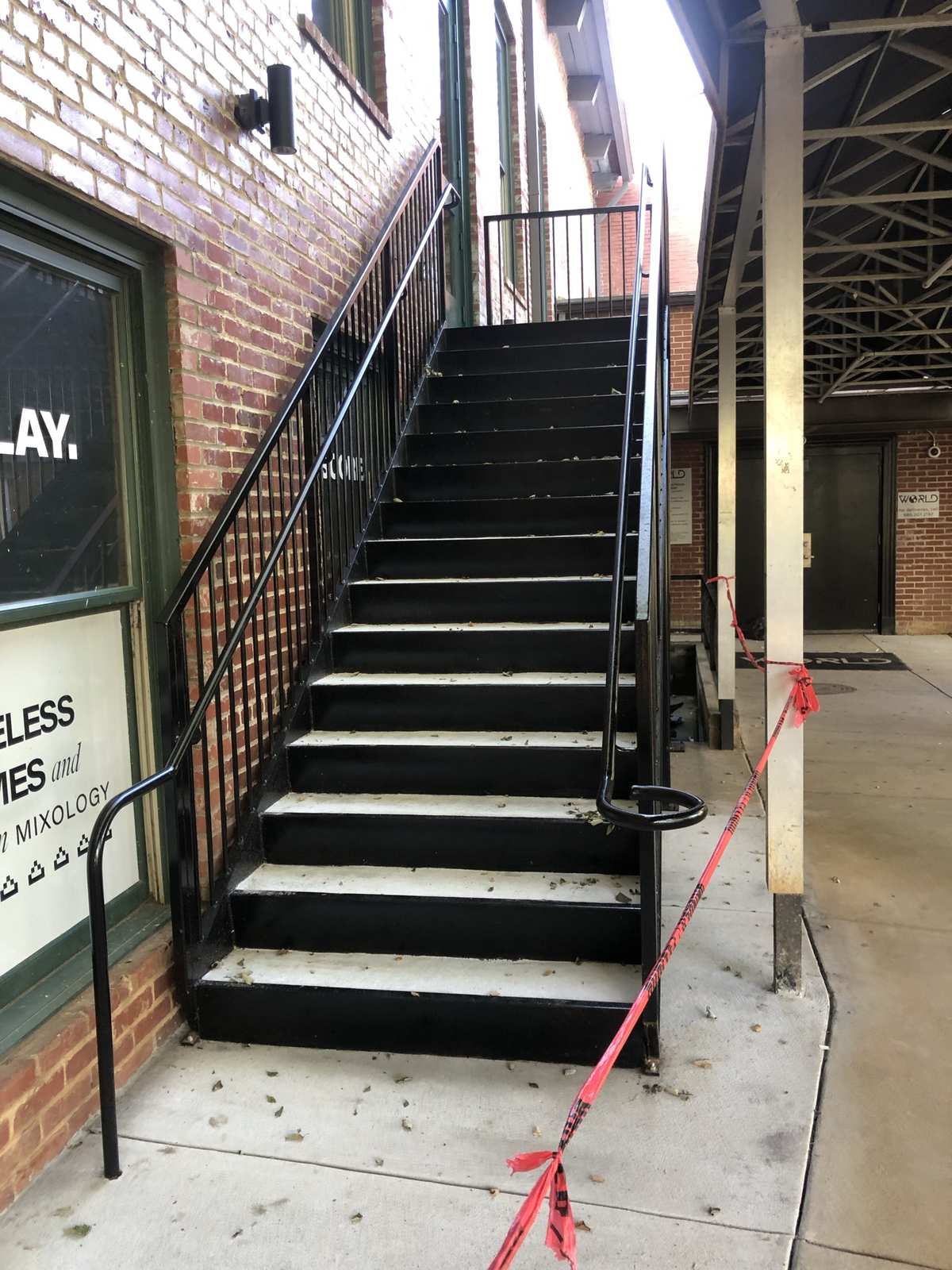 Exterior steel staircase with handrails on a brick commercial building